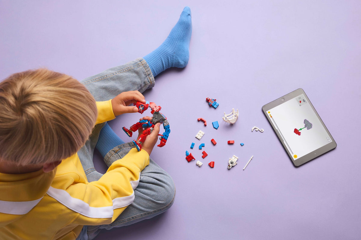 Child building LEGO 76308